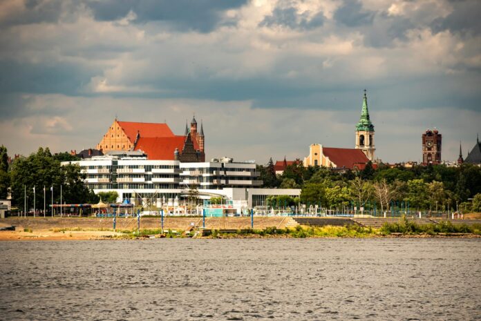 Explore the picturesque skyline of Torun with iconic churches and riverside beauty.
